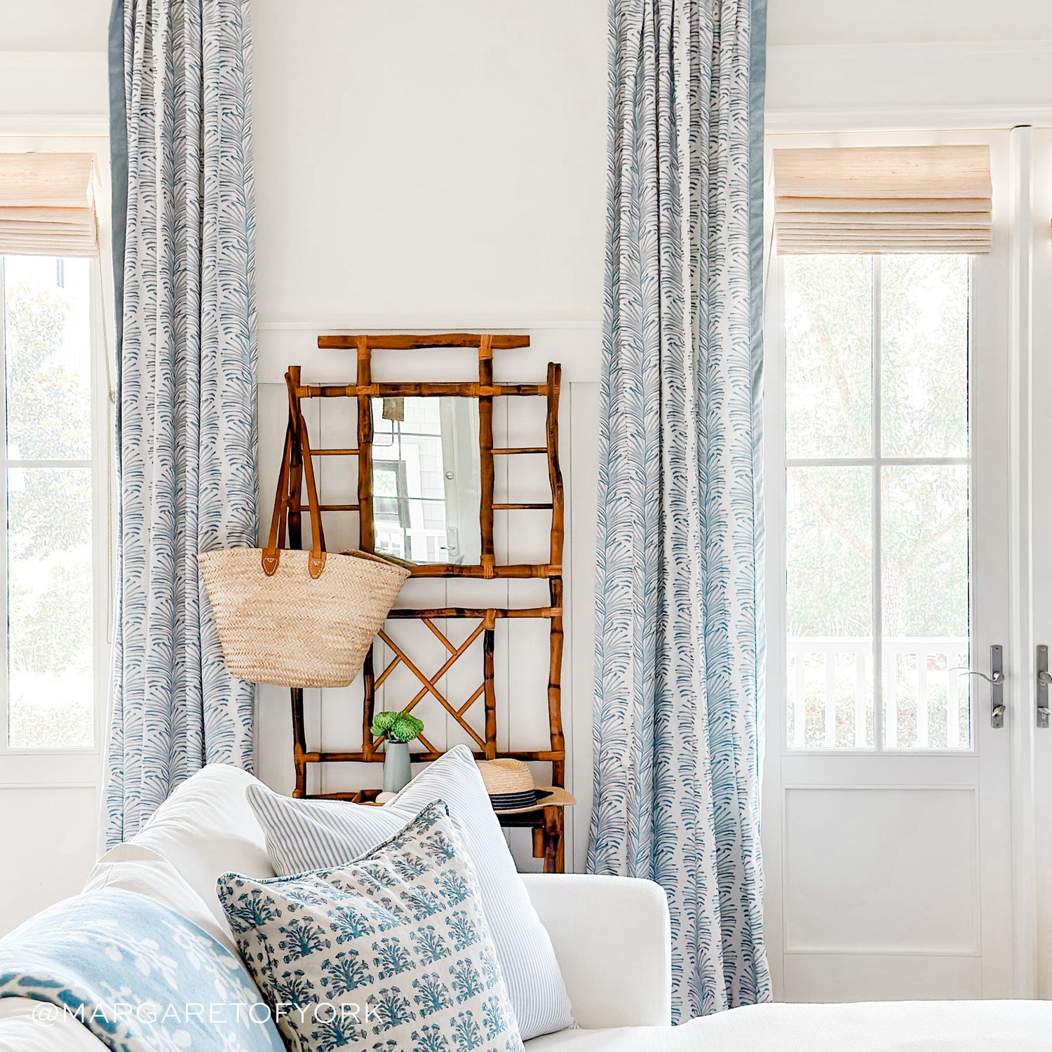 Sky Blue Botanical Stripe Printed Curtains on living room next to couch with blue printed pillows. Photo taken by Margaret of York
