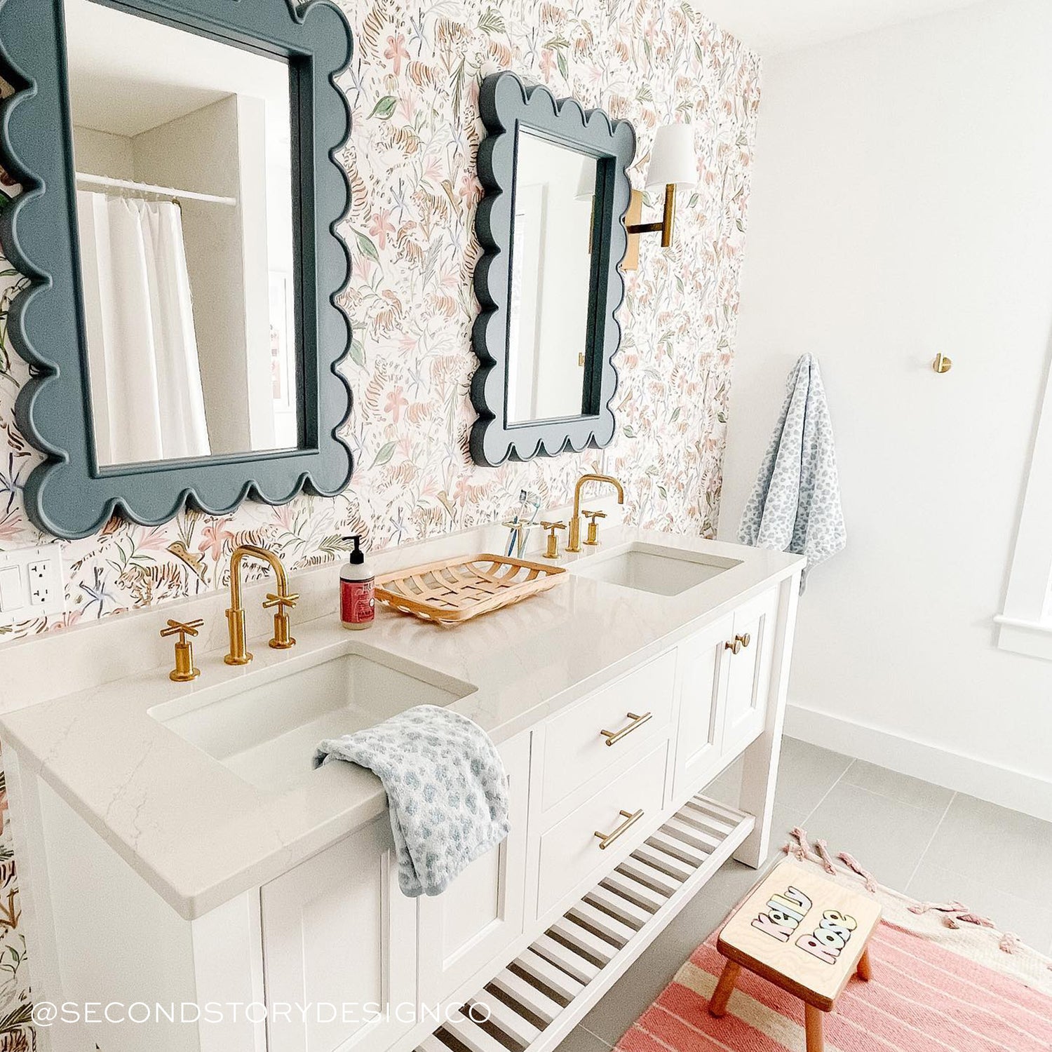 Bathroom with white double zinc and green mirrors on top of each styled with Pink Chinoiserie Tiger Printed Wallpaper. Photo taken by Second Story Design Co