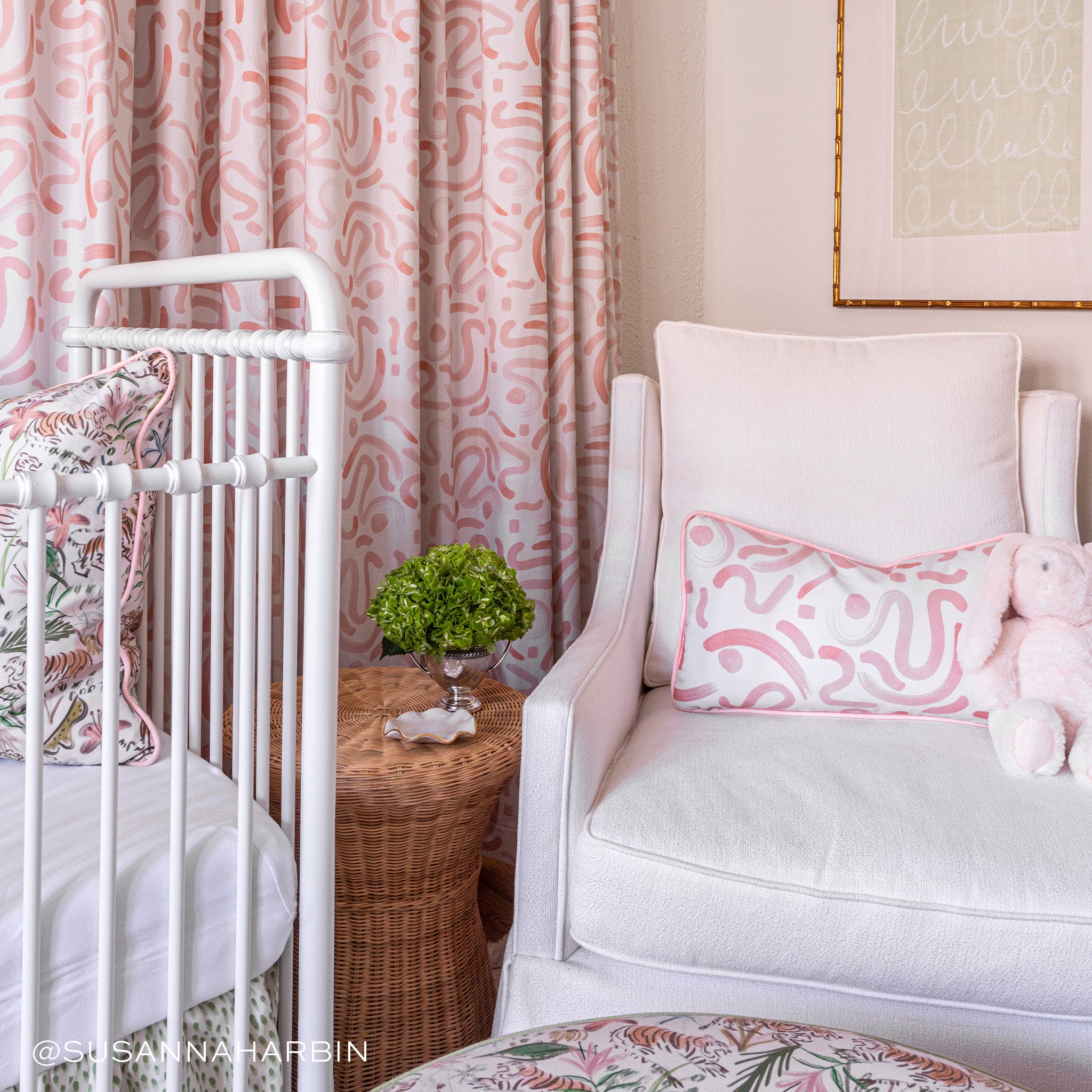 Nursery room corner styled with Pink Graphic Printed Lumbar on Pink Sofa Chair next to white crib with Pink Chinoiserie Printed Pillow. Photo taken by Susanna Harbin Interiors