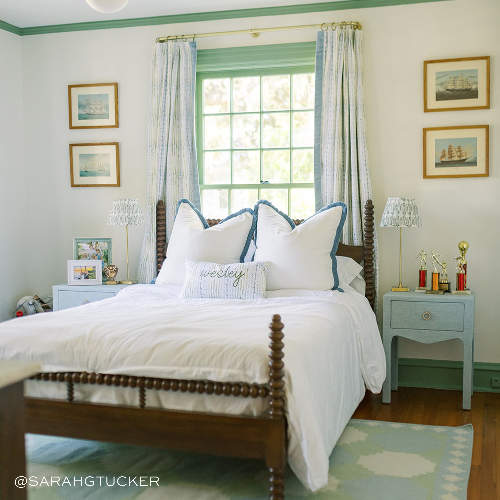 Bedroom styled with Blue & Green Striped Custom Curtains next to bed with two Linen Oat Custom Pillows and one Blue & Green Striped Custom Lumbar Pillow with two blue night stands on each side. Photo taken by Sarah G Tucker
