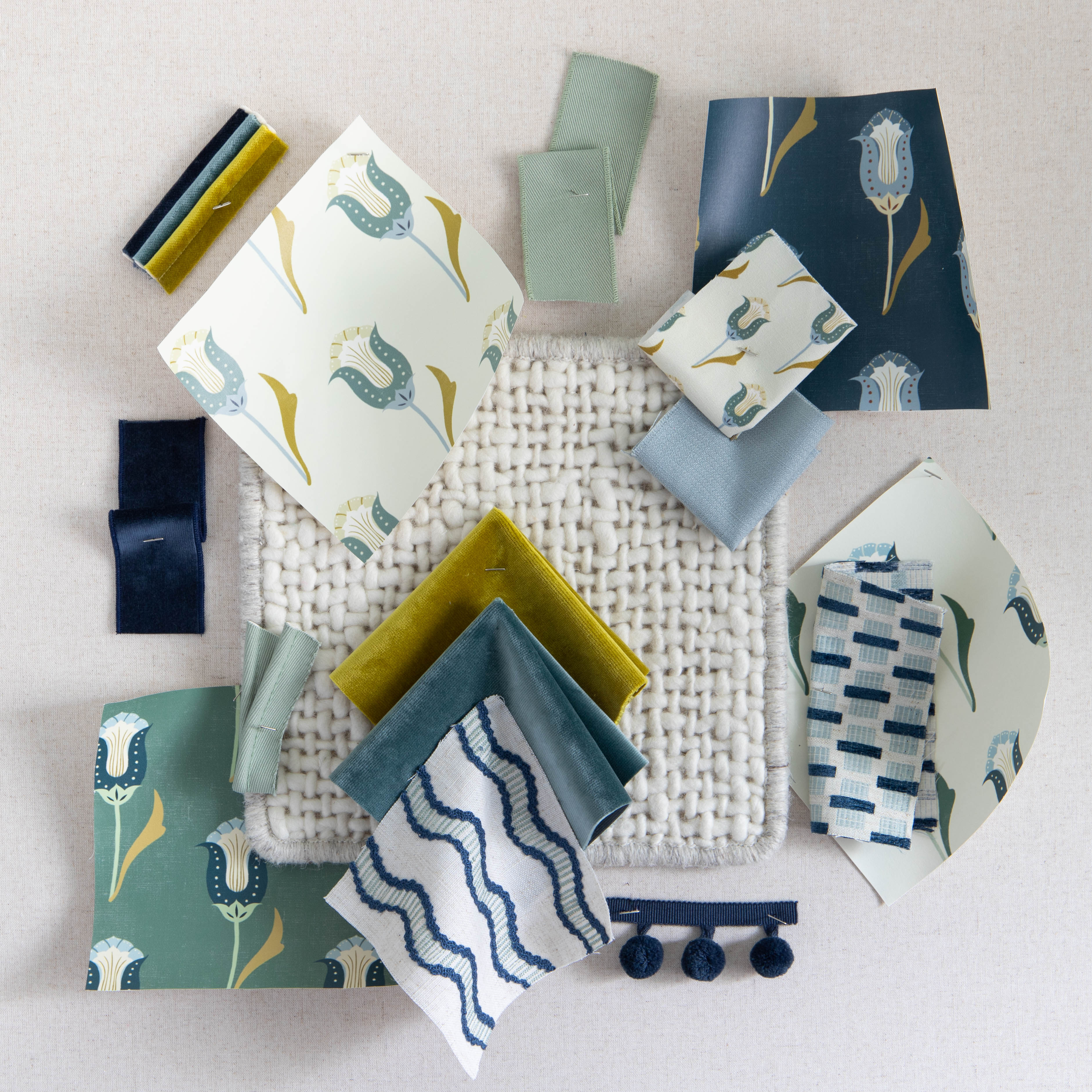 interior design mood board with blue, green, and floral fabric swatches and trim options.