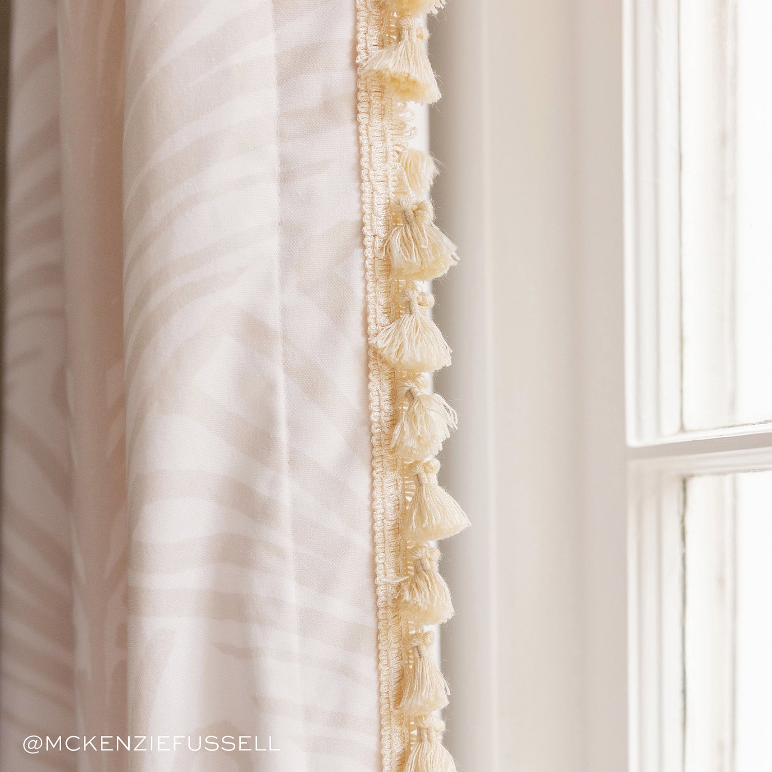 Close-up of Beige Palm Printed Curtain with cream tassel. Photo taken by Mckenzie Fussell