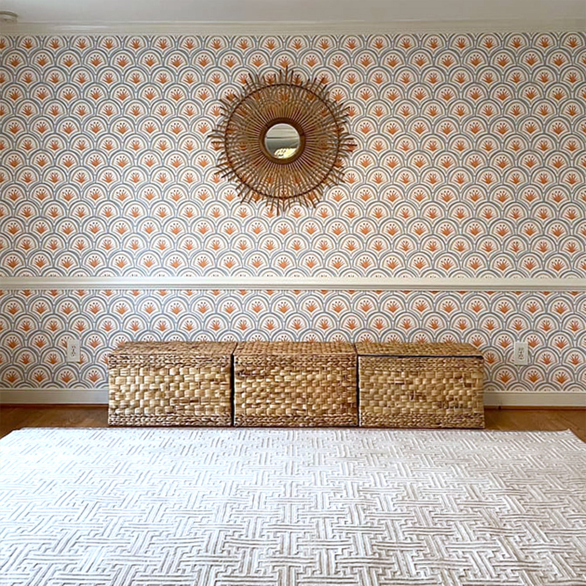 Room styled with Art Deco Palm Pattern Printed Wallpaper and mirror hung in the middle with three brown boxes below