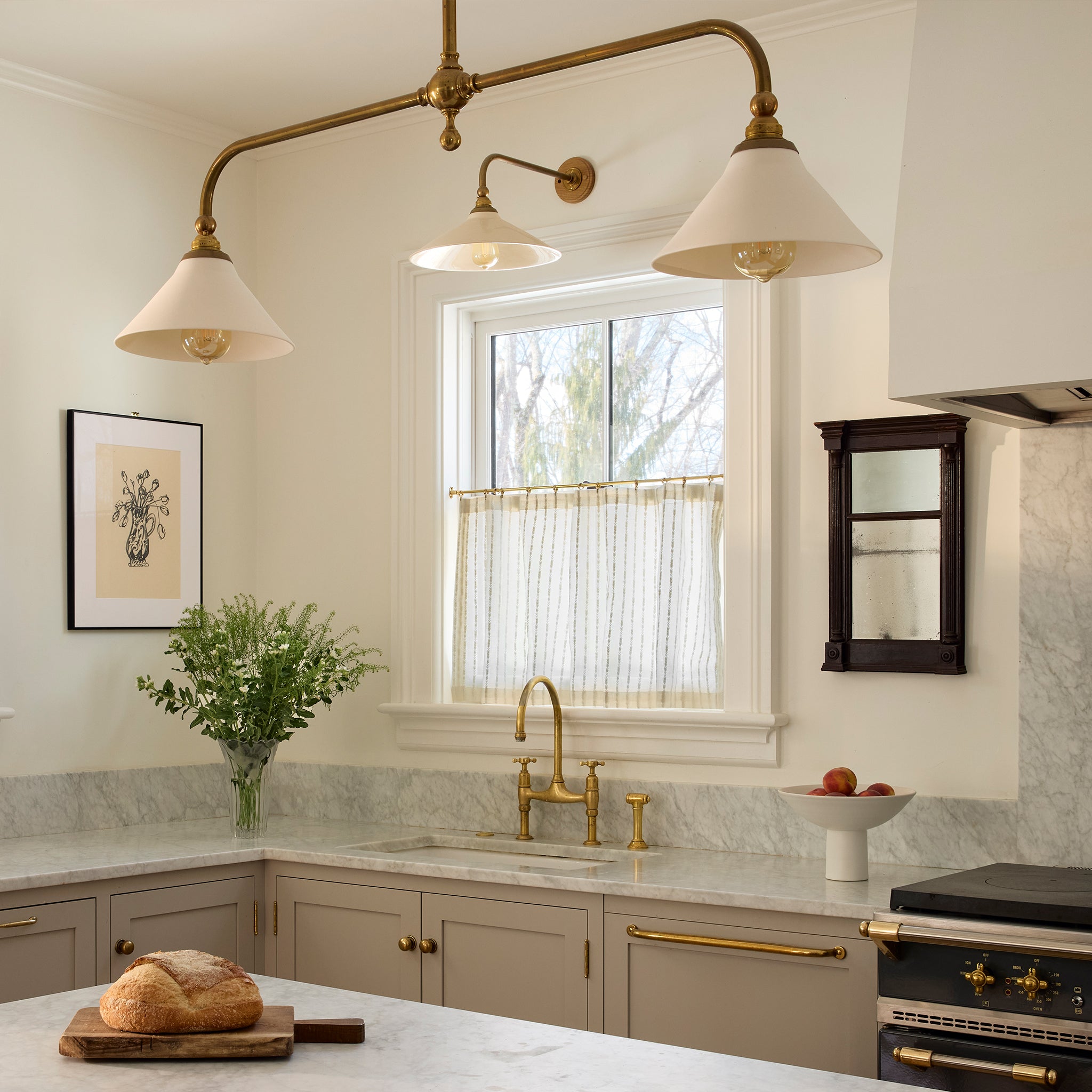 Bright kitchen window with custom sheer Madeline Flour curtains featuring embroidered stripes on ivory fabric
