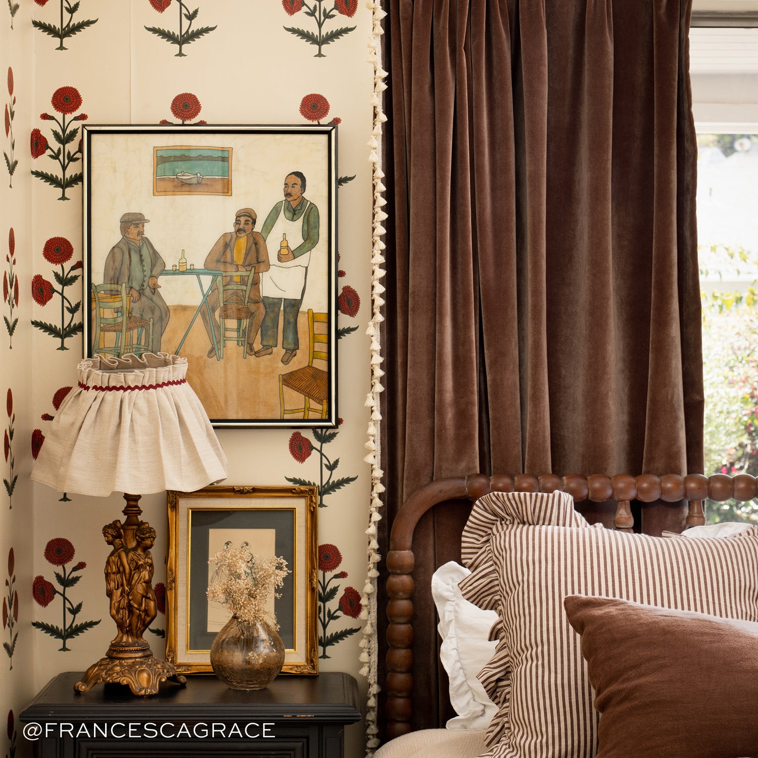 Corner close-up with Brown Velvet Curtains next to bed with brown striped pillow and brown pillow next to wooden nightstand with lamp and decorations on top. Photo taken by Francesca Grace