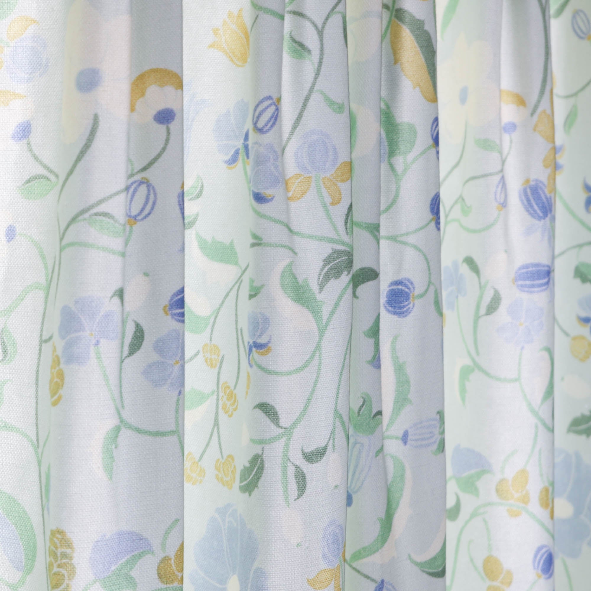 Lulie Eggshell custom sheer curtains with hand-painted verdant floral pattern inspired by a breezy backyard garden.