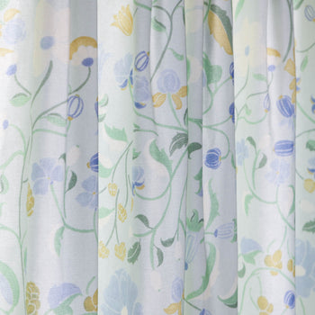 Lulie Eggshell custom sheer curtains with hand-painted verdant floral pattern inspired by a breezy backyard garden.