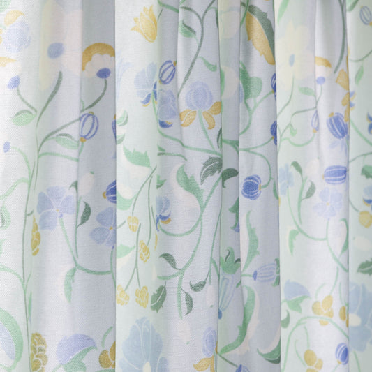 Lulie Eggshell custom sheer curtains with hand-painted verdant floral pattern inspired by a breezy backyard garden.