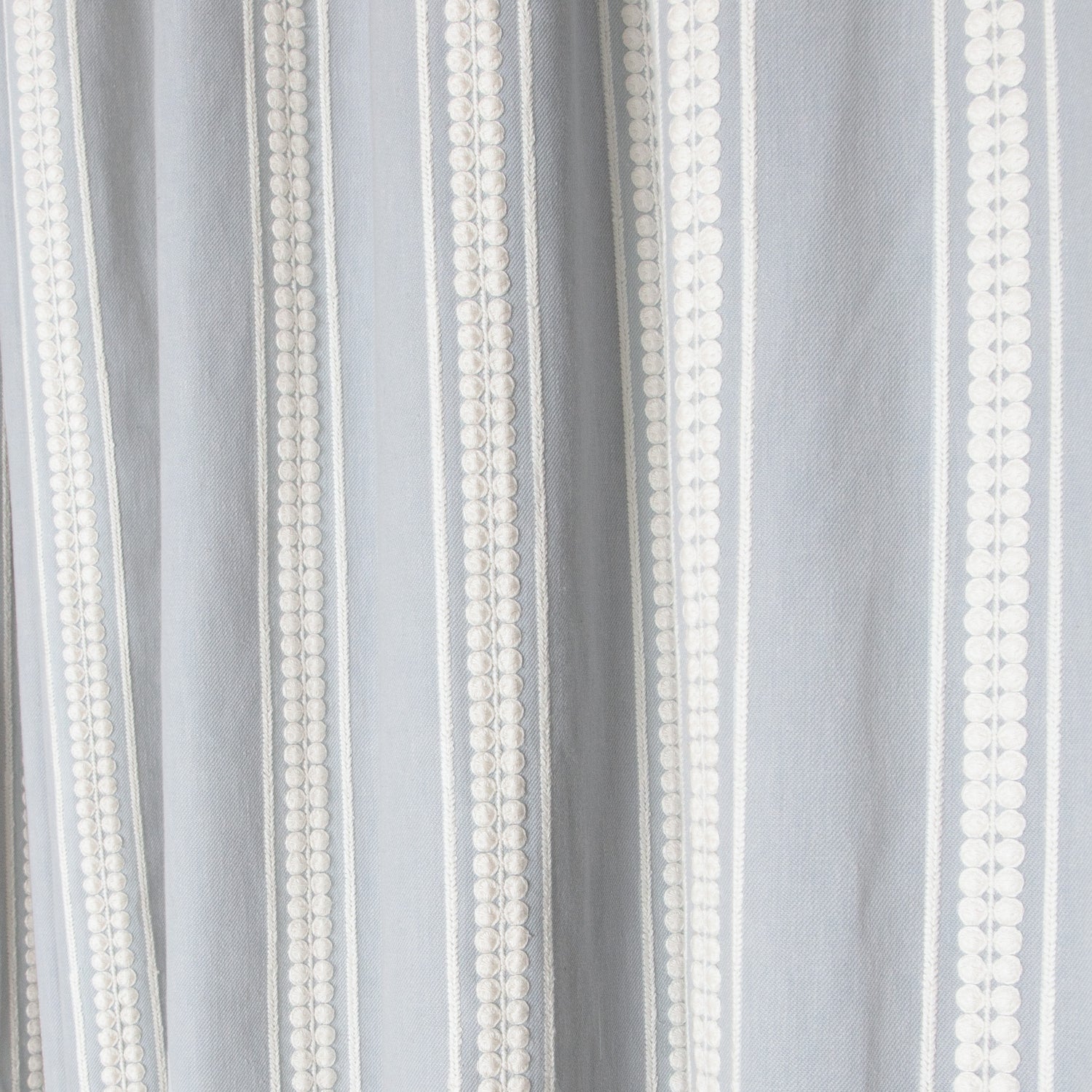 Soft textured fabric with vertical white embroidered stripes, showcasing Margot Mist Unlined custom sheer curtains by Pepper Home.