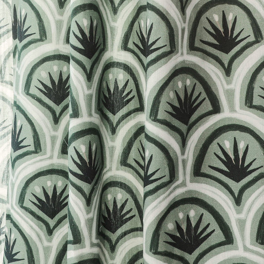 Close-up of the custom Thatcher Forest Unlined curtain fabric with green and black botanical pattern by Pepper Home.