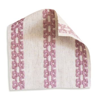 Lilith fabric swatch showcasing custom embroidered pink bow stripes on natural linen-blend for Pepper Home curtains.