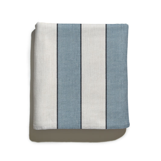 Folded Florence Harbor custom curtain fabric with classic blue and white stripes and scalloped border detail.