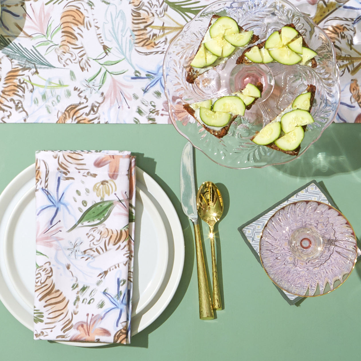 Table setting close-up with white plated and gold silverware styled with Pink Chinoiserie Tiger Printed Table runner and Pink Chinoiserie Tiger Printed Napkin