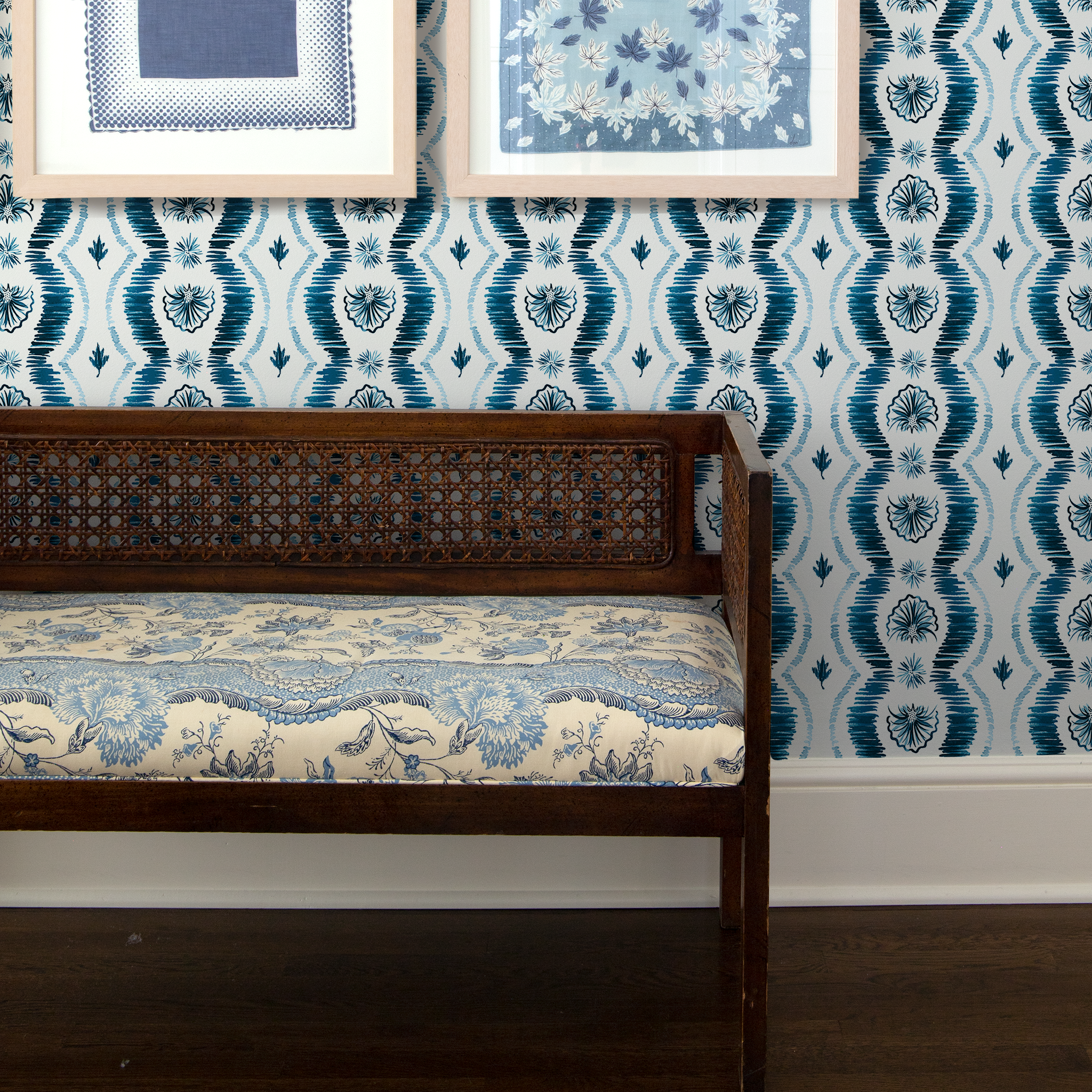 Wooden bench in front of Blue Ikat Striped Pattern Wallpaper with two paintings hanging