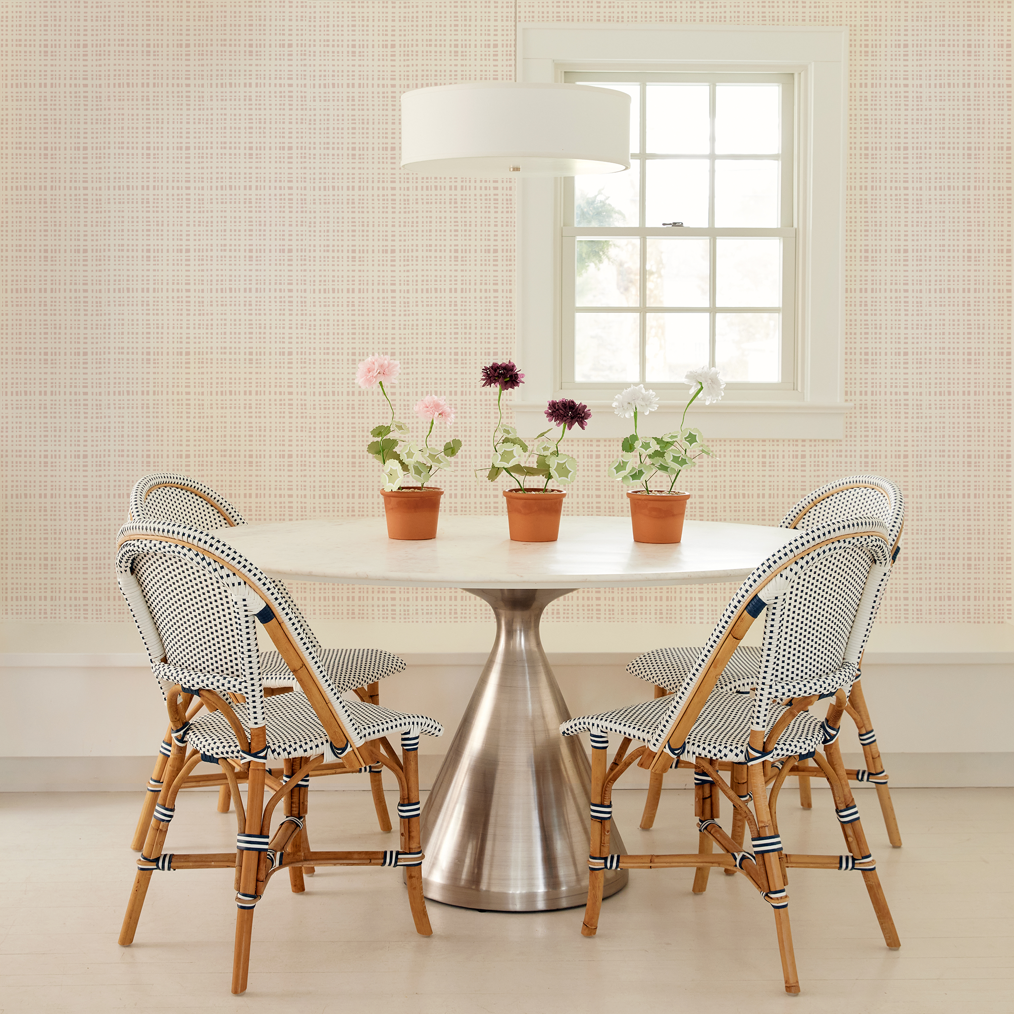 Dining room with Pepper Home Ginger Rose gingham wallpaper and modern metal table with custom cafe-style chairs