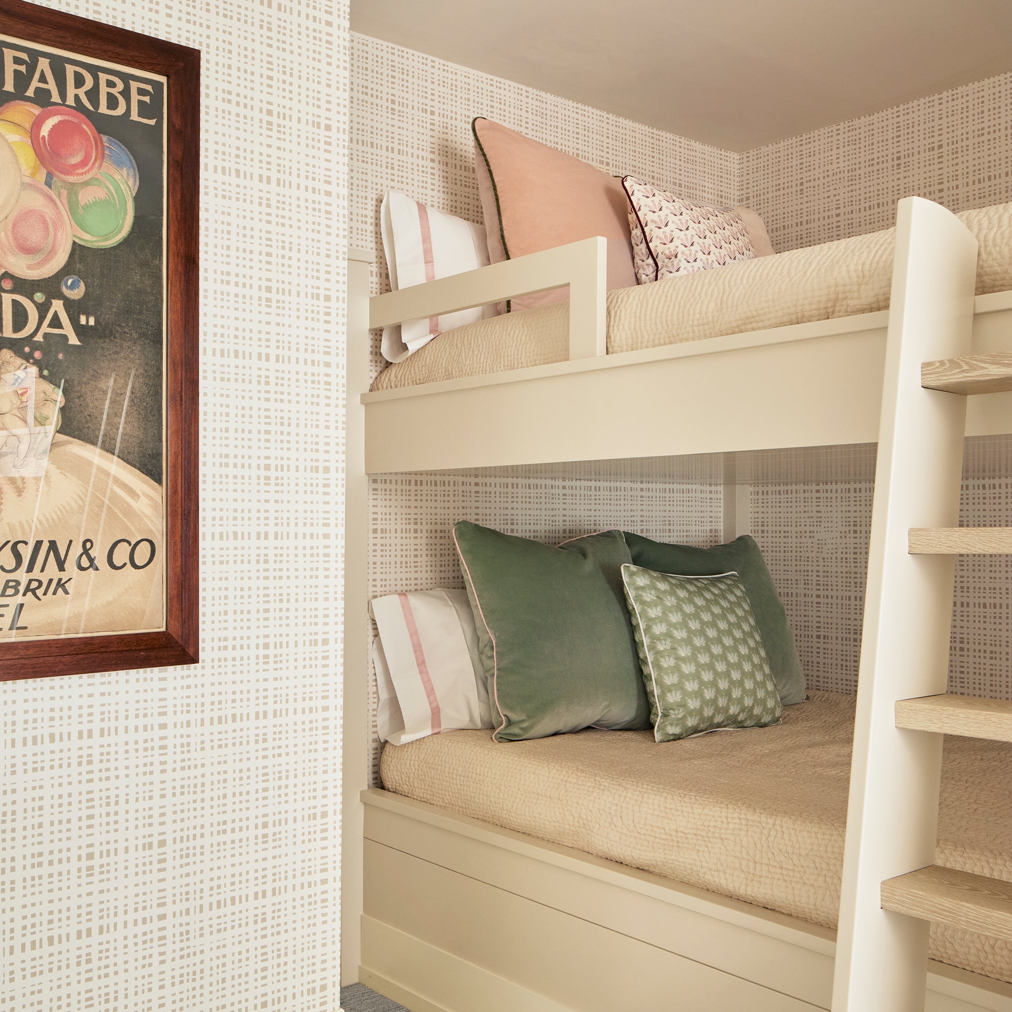 Bedroom corner styled with Beige Gingham Printed Wallpaper by bunk beds with two Blue Green Velvet Pillows with one Coastal Inspired Green and Blue Printed Pillow on bottom bunk bed and two pink velvet pillows with one Pink & Burgundy Drop Repeat Floral Printed pillow on top bunk bed