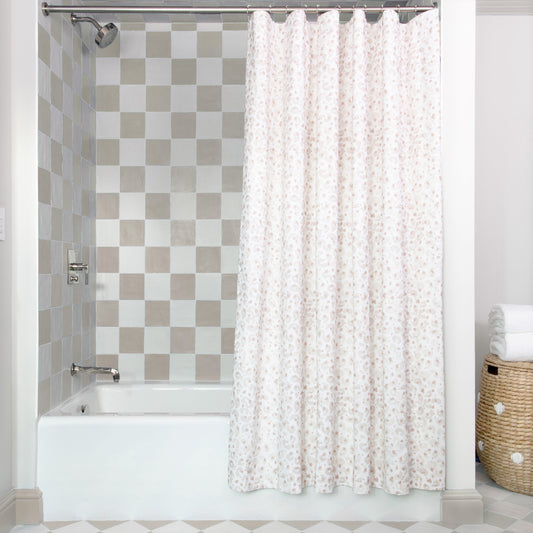 Beige Animal Print shower curtain hanging on rod in front of white tub in bathroom with light brown and white tiles