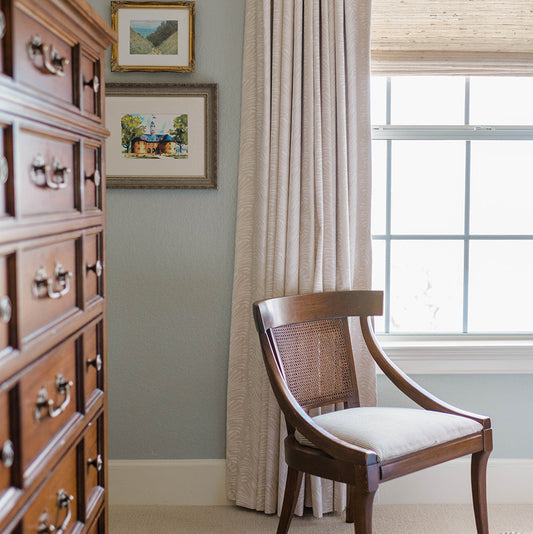 Corner styled with Beige Botanical Stripe Custom Curtain in front of illuminated window with wooden chair next to wooden drawers
