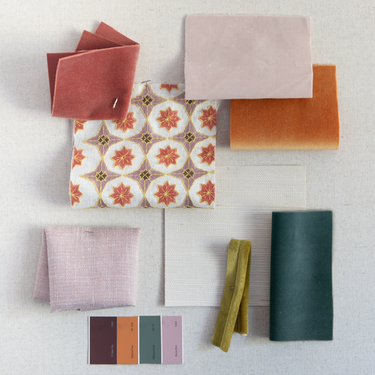 A fabric mood board featuring a mix of warm and cool tones and a coral embroidered fabric that showcases an intricate geometric floral pattern in deep coral, accented with gold outlines and soft lavender details.