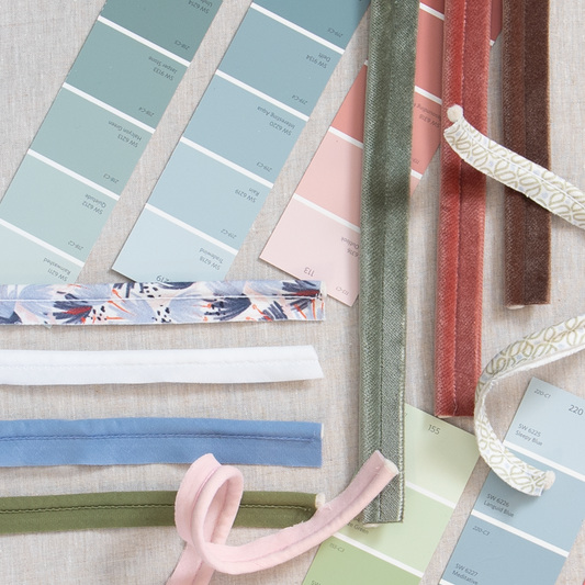 Interior design moodboard with blue and pink paint chips and cotton and velvet piping pieces