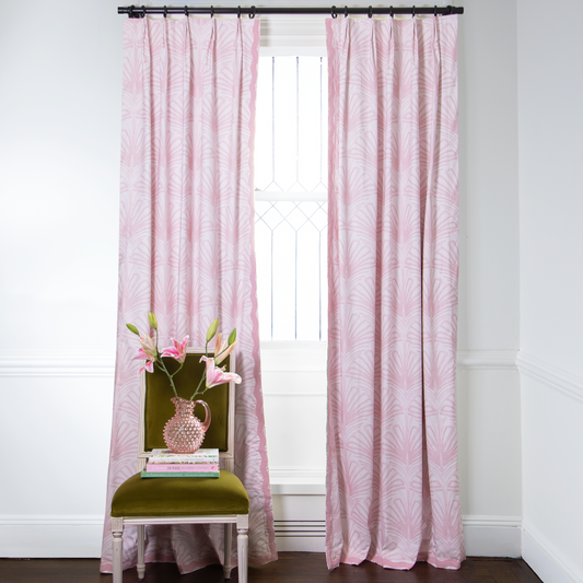Rose pink palm custom curtain haning on window in room with white walls and green chair