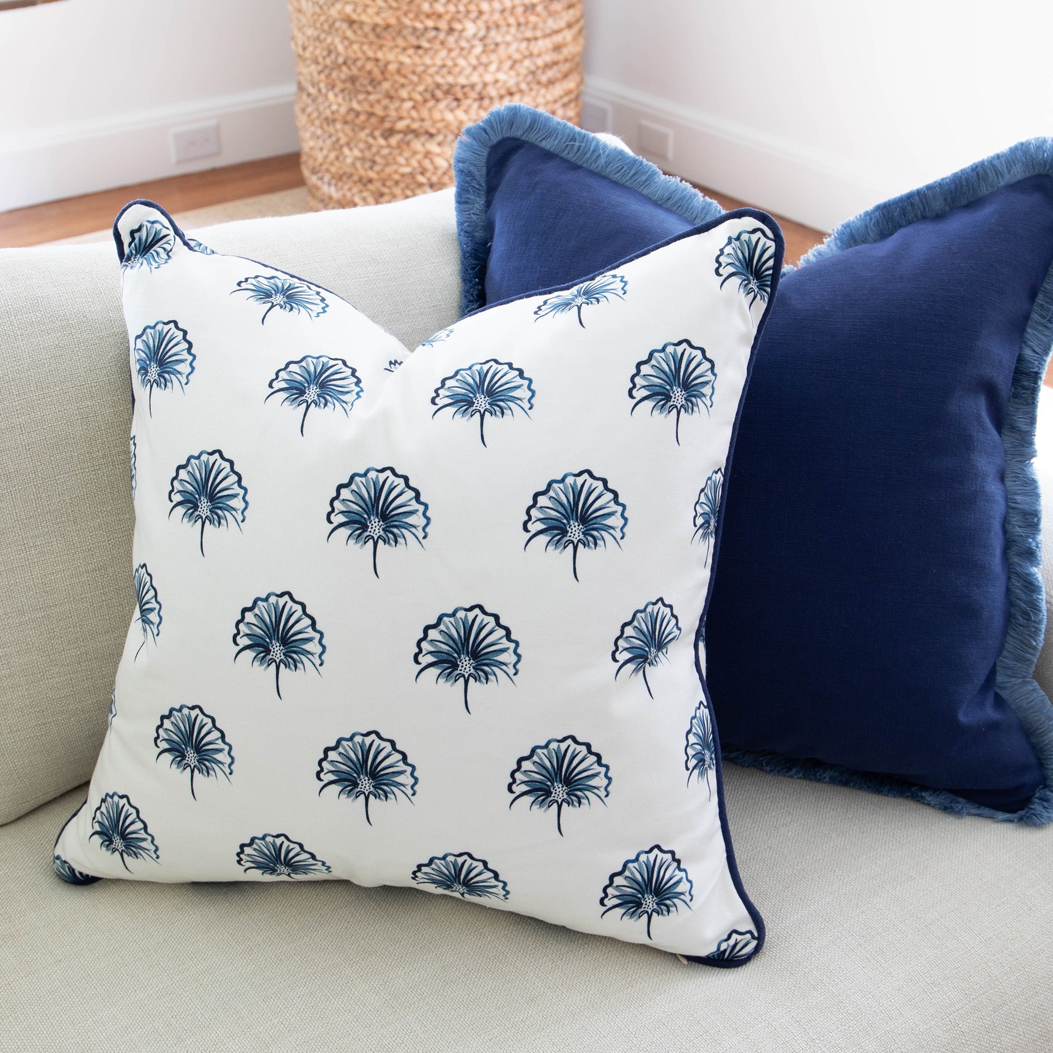 Couch close-up with Navy Blue Pillow with navy fringe and Floral Navy Printed Pillow with Navy Piping