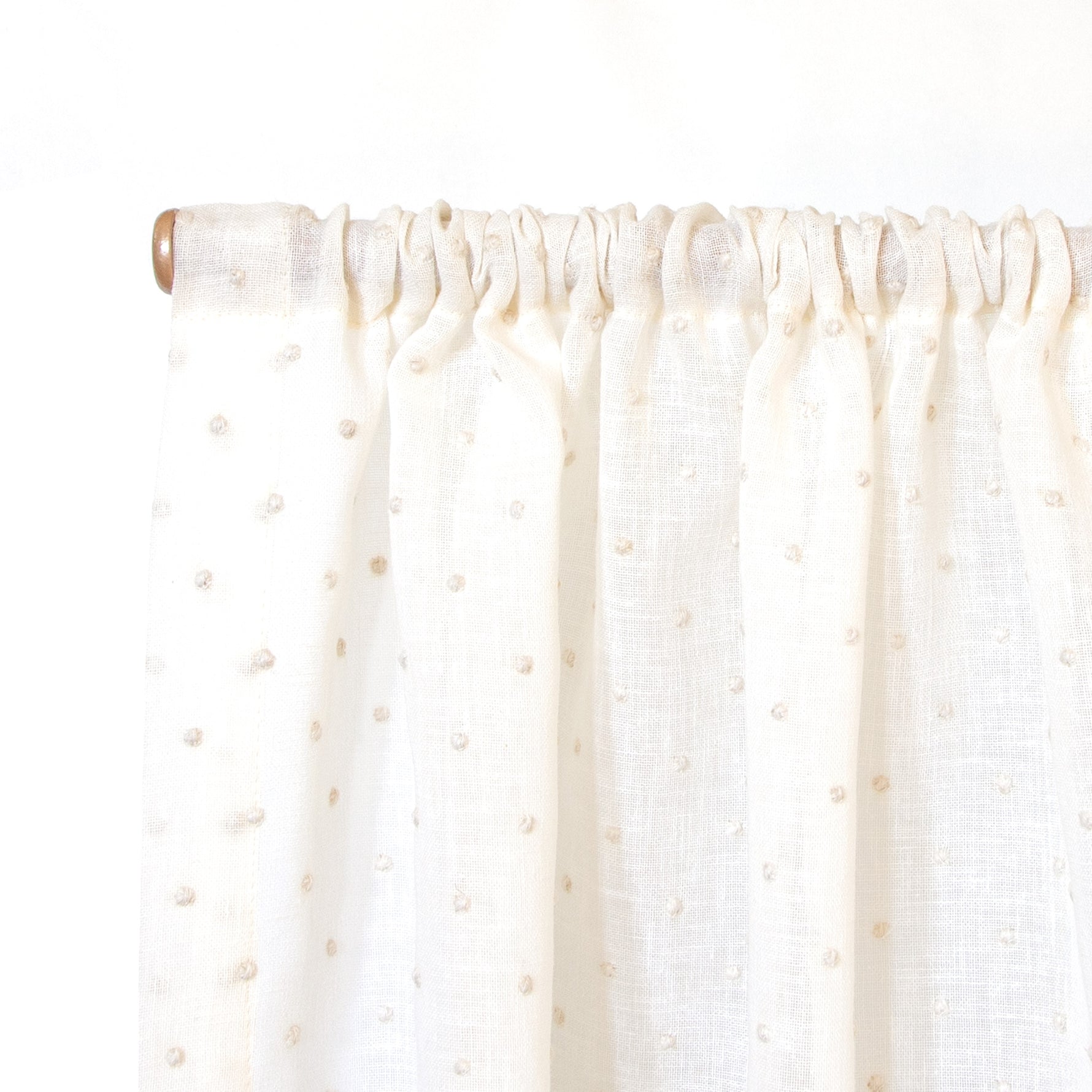 close up of sheer white with embroidered cream polka dot rod pocket cafe curtain 