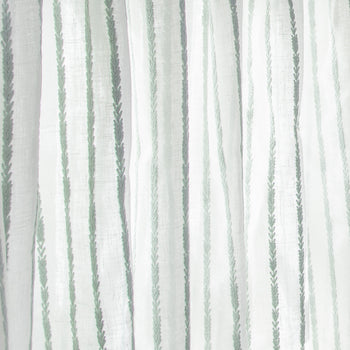 close up of sheer white curtain with embroidered mint green stripe pattern