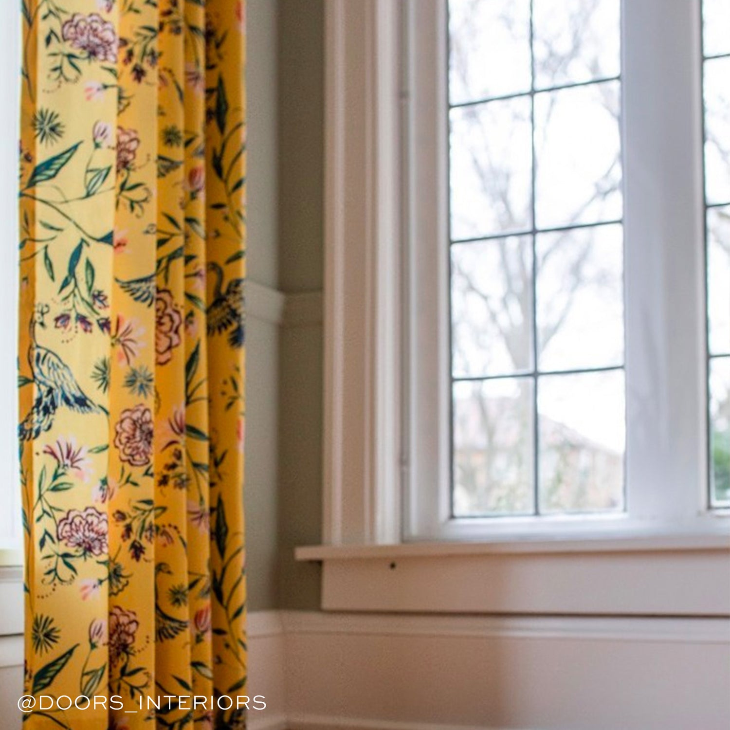 Yellow Canary Printed Custom Curtains next to a window. Photo by @Doors_Interiors