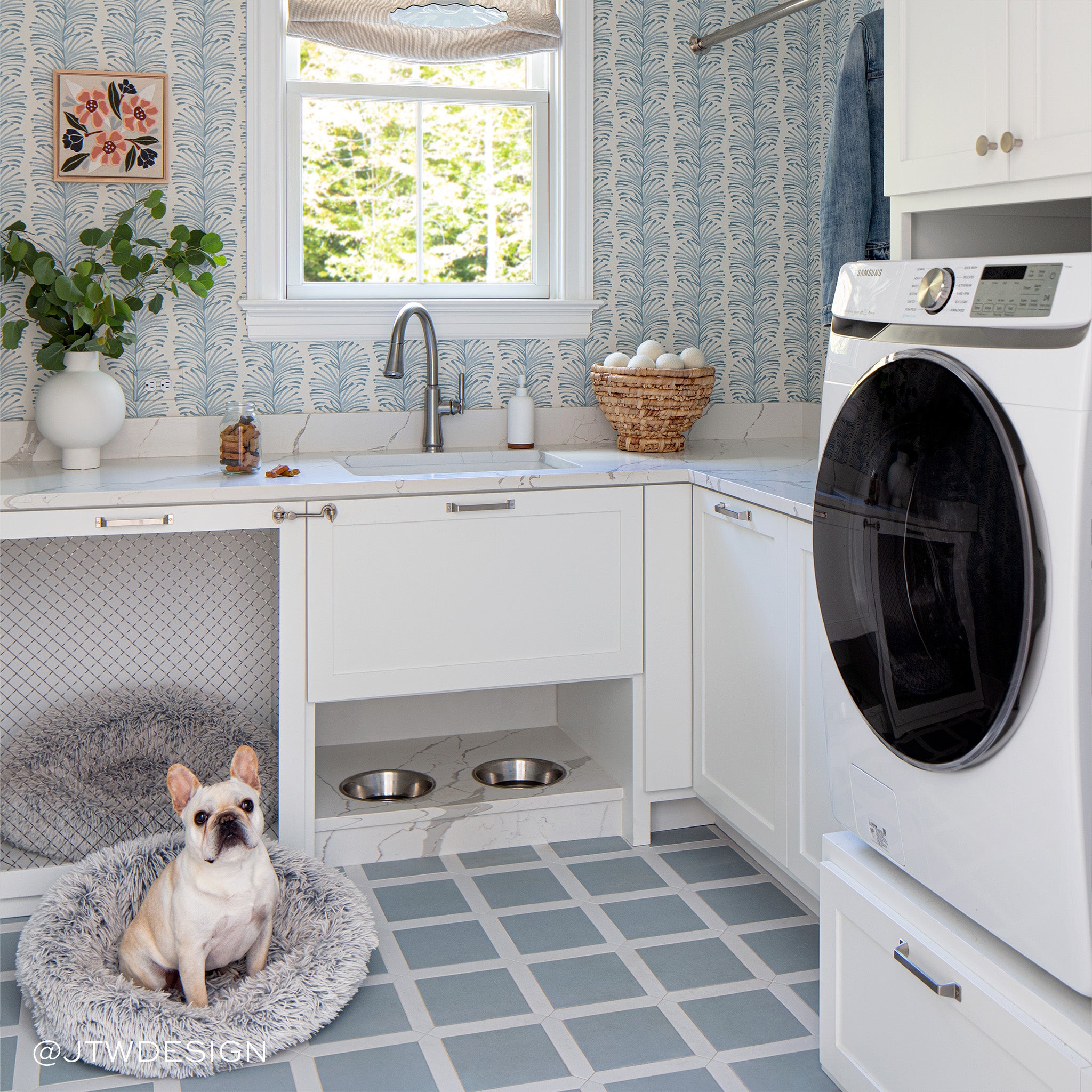 Laundry room styled with Sky Blue Botanical Stripe Printed Wallpaper and white countertop with dog in grey bed on the floor to the left. Photo taken by JTW Design