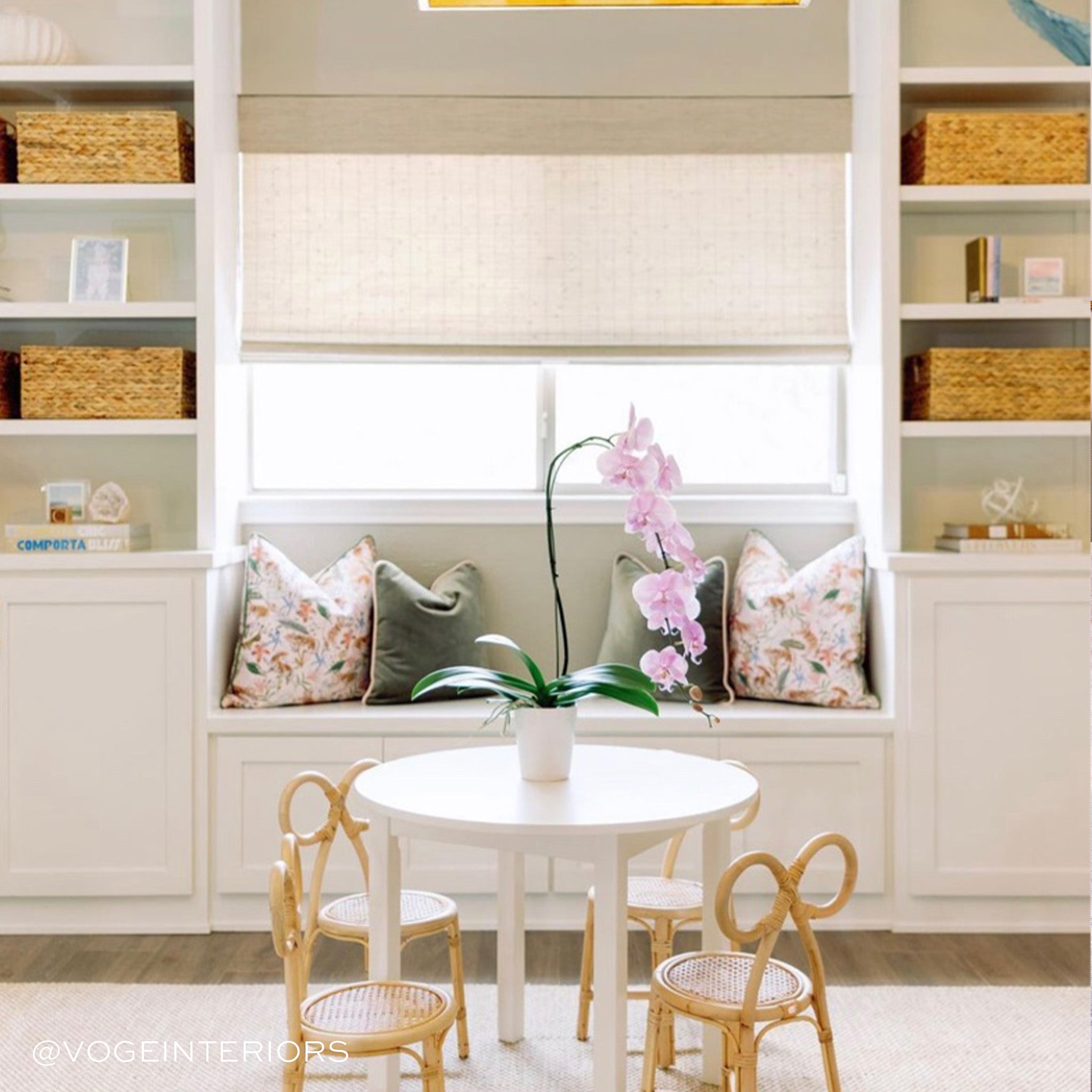 Playroom styled with two Fern Green Velvet Pillows and two Pink Chinoiserie Tiger Printed pillows facing each other next to white table for kids with four chairs. Photo taken by Voge Interiors