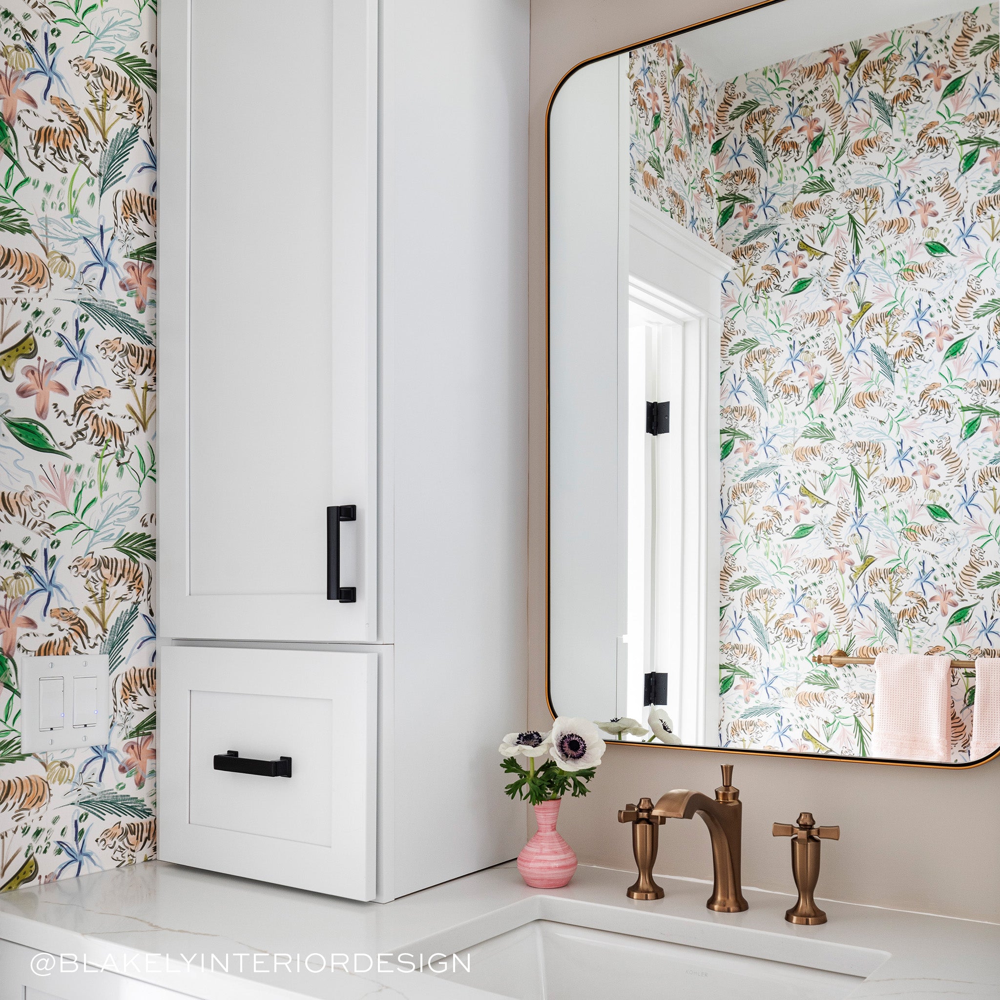 Bathroom corner close-up with white cabinets styled with Pink Chinoiserie Tiger Printed Wallpaper. Photo taken by Blakely Interior Design