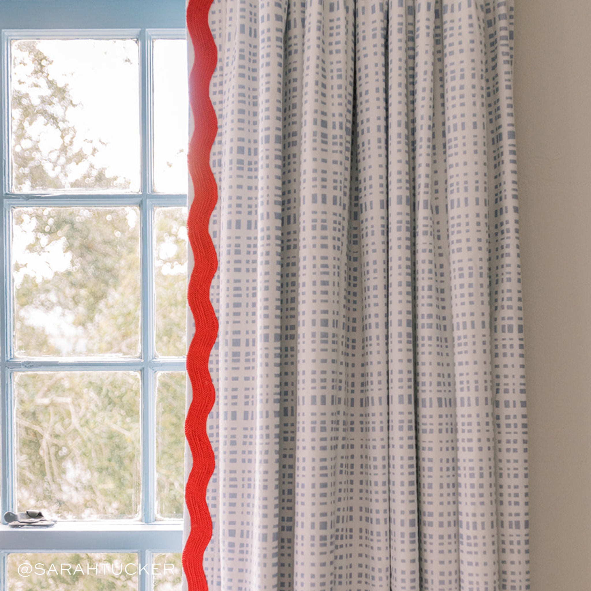 Sky Blue Gingham Curtain with red band Close-Up next to window. Photo taken by Sarah Tucker