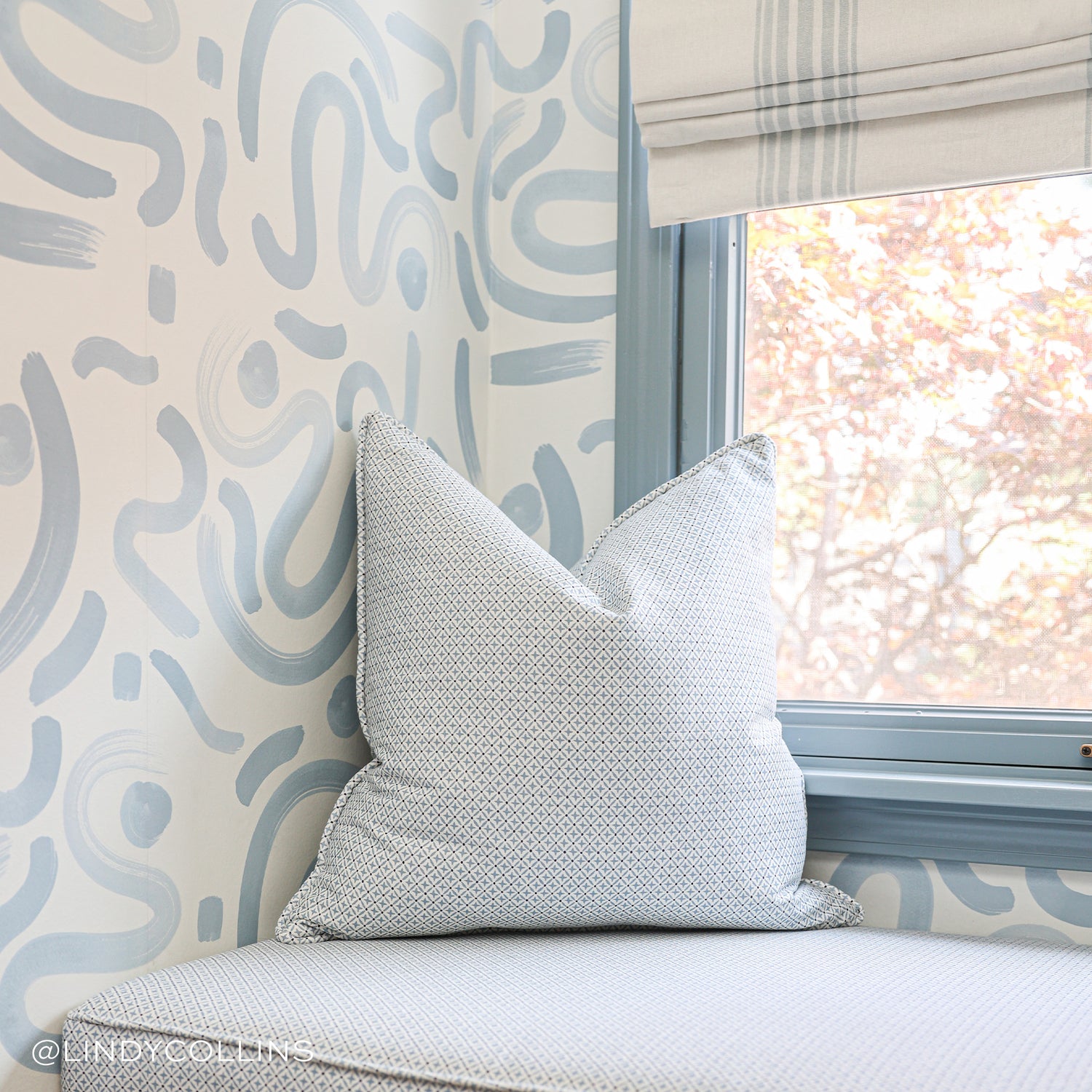 Window close-up of Sky Blue Printed Wallpaper with Blue and White Printed Pillow. Photo taken by Lindy Collins