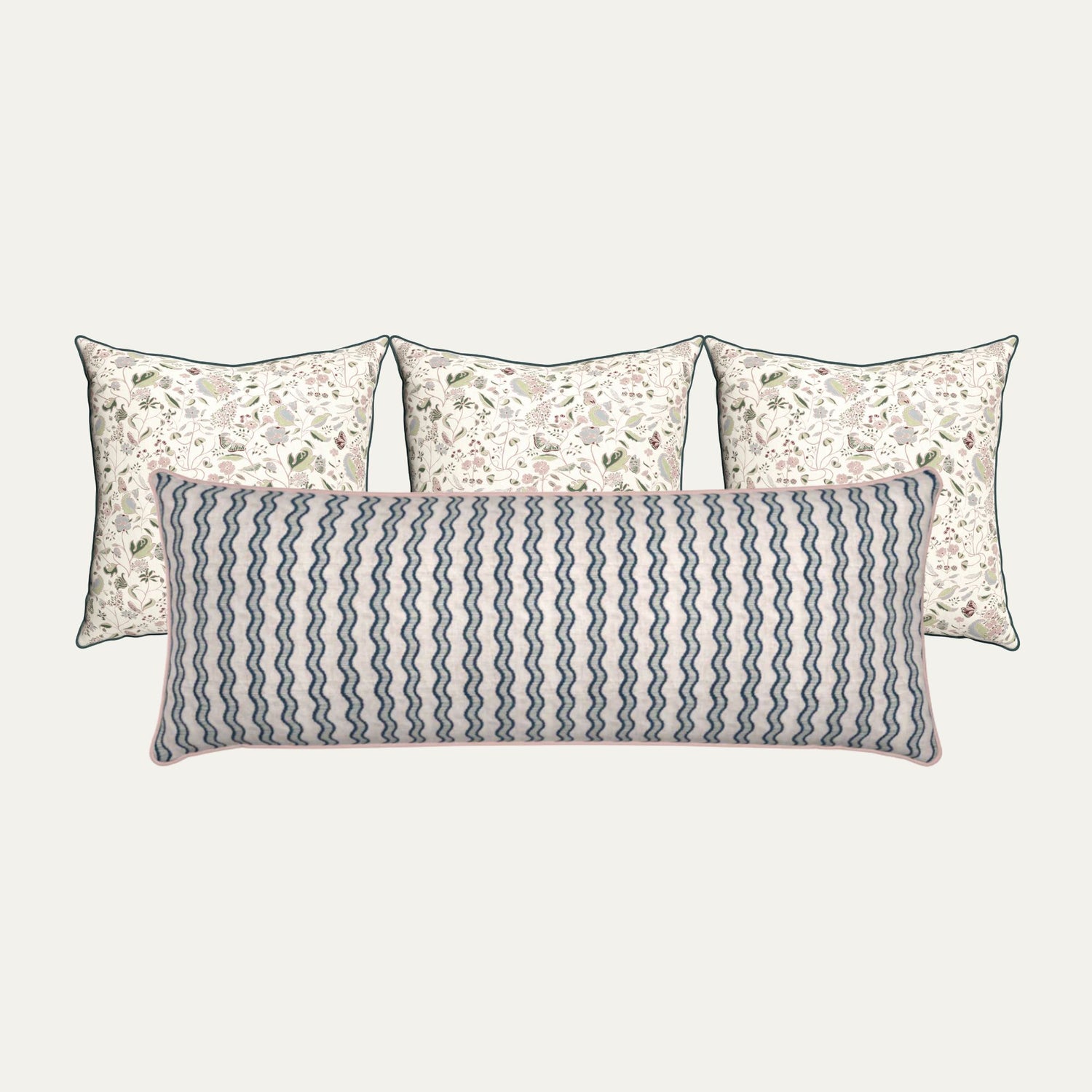 Jennifer Hunter pillow bundle featuring three floral square pillows and one long lumbar pillow with blue wavy stripes