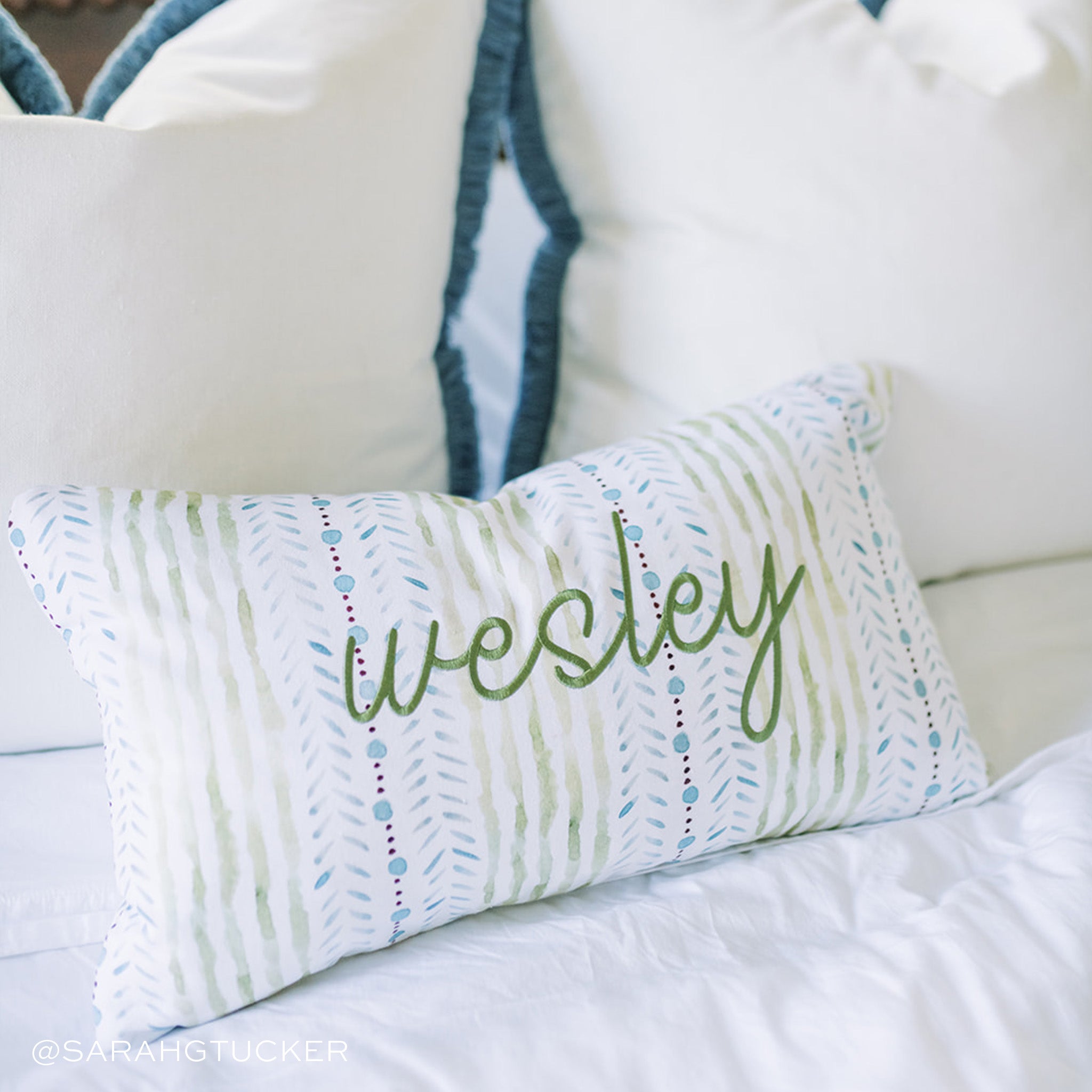 Close-up of Blue & Green Striped Printed Monogrammed Lumbar over two Linen Oat Pillows. Photo taken by Sarah G Tucker
