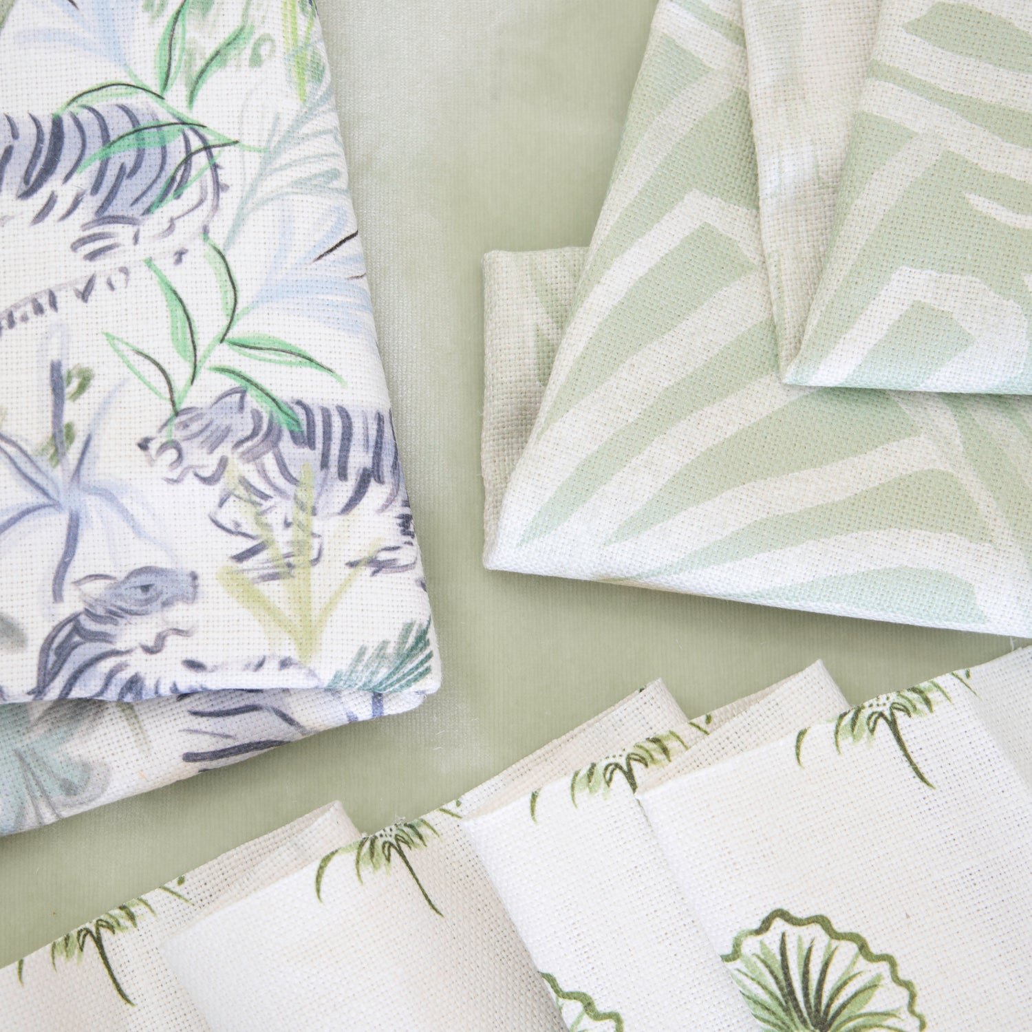 Interior design moodboard and fabric inspirations close-up with Green Tiger Printed Linen Swatch, Green Floral Printed Linen Swatch, and Sage Green Printed Linen Swatch
