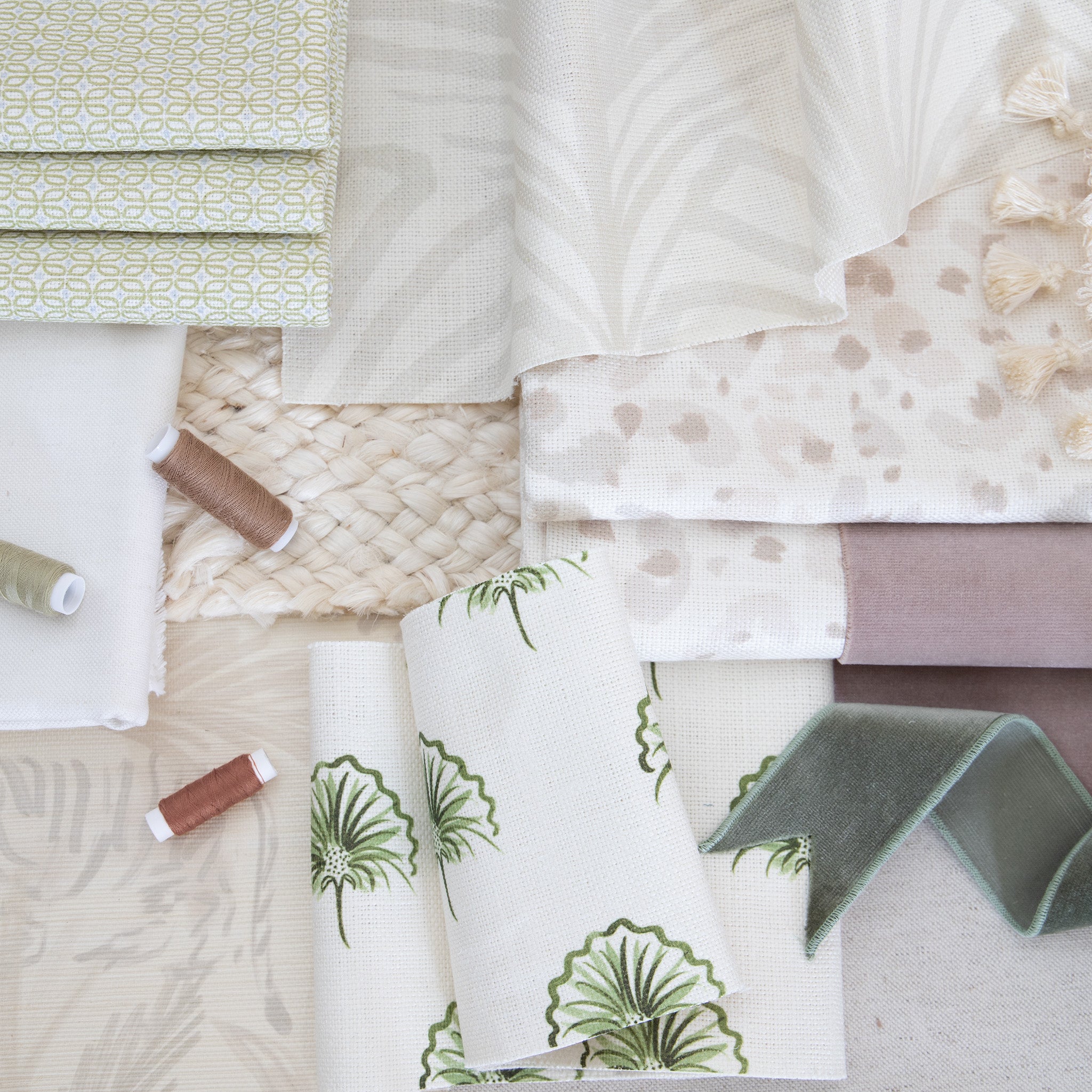 interior design mood board with White Cotton Swatch, neutral animal print swatch, moss green floral repeat pattern fabric swatch, moss green geometric fabric swatch, and green and light brown thread