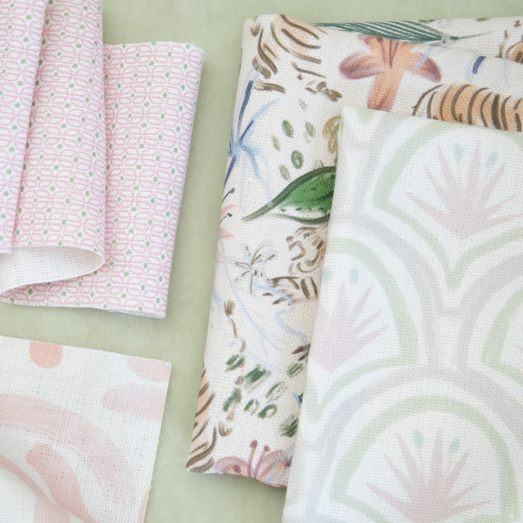 Interior design moodboard and fabric inspirations close-up with Pink Chinoiserie Tiger Printed Linen Swatch, Art Deco Palm Pattern Printed Linen Swatch, Pink Graphic Printed Linen Swatch, and Pink Geometric Printed Linen Swatch