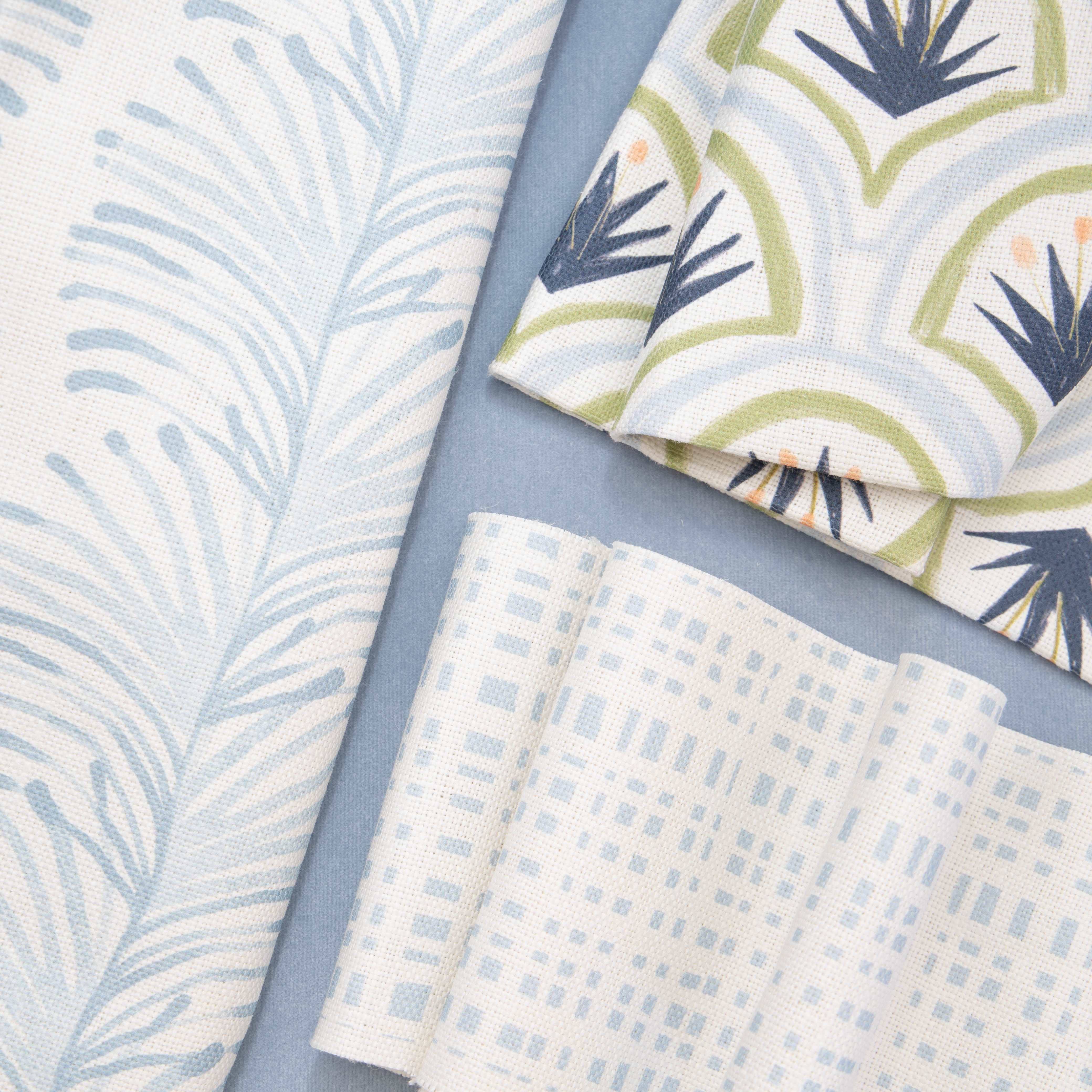 Close-up of Interior design moodboard and fabric inspirations with Sky Blue Gingham Printed Swatch, Sky Blue Botanical Stripe Printed Swatch, and Sky and Art Deco Palm Pattern Printed Swatch