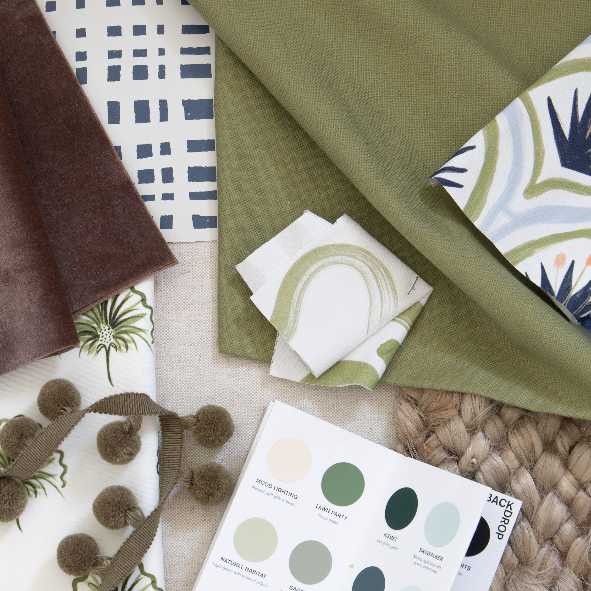 interior design mood board with moss green fabric abstract and botanical moss green fabric swatches and blue and green paint swatches 