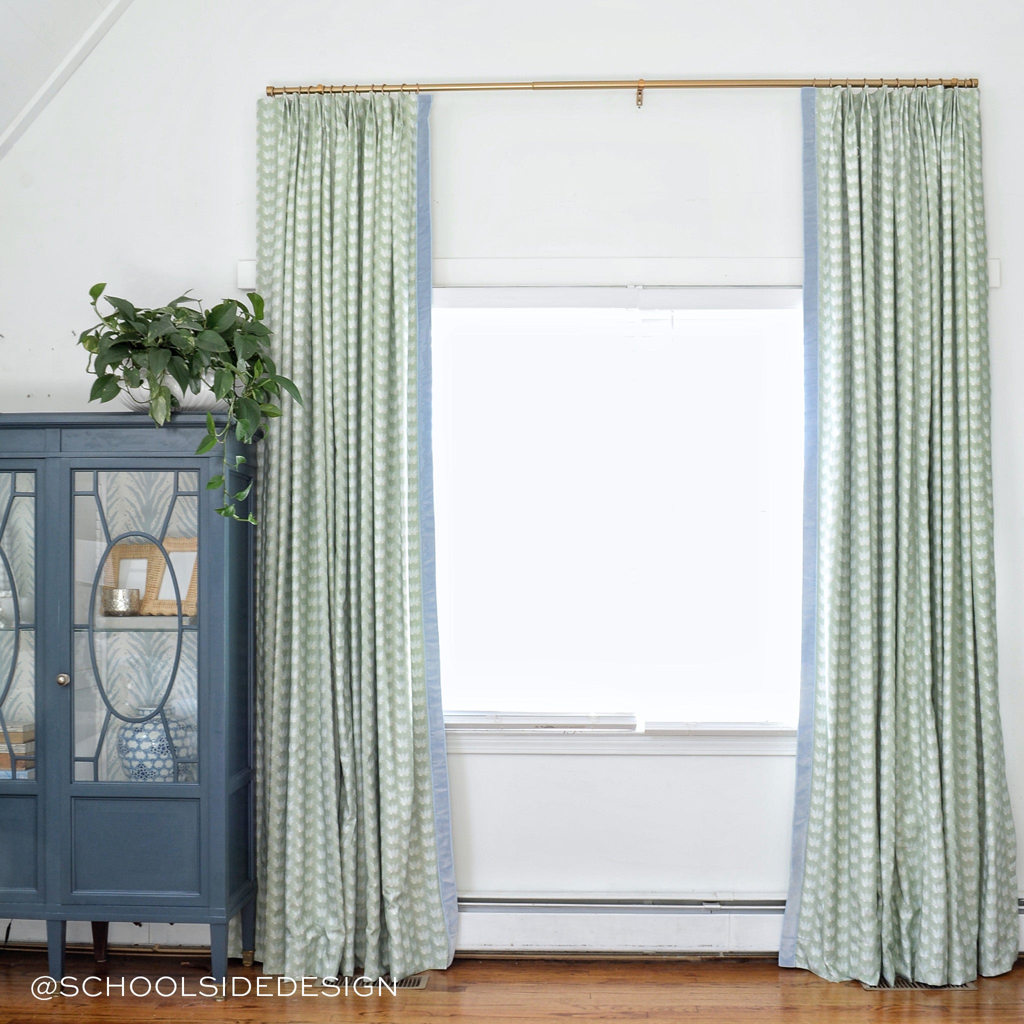 Window styled with Blue & Green Floral Drop Repeat Printed Curtains with sky blue band next to navy blue cabinets. Photo taken by School Side Design