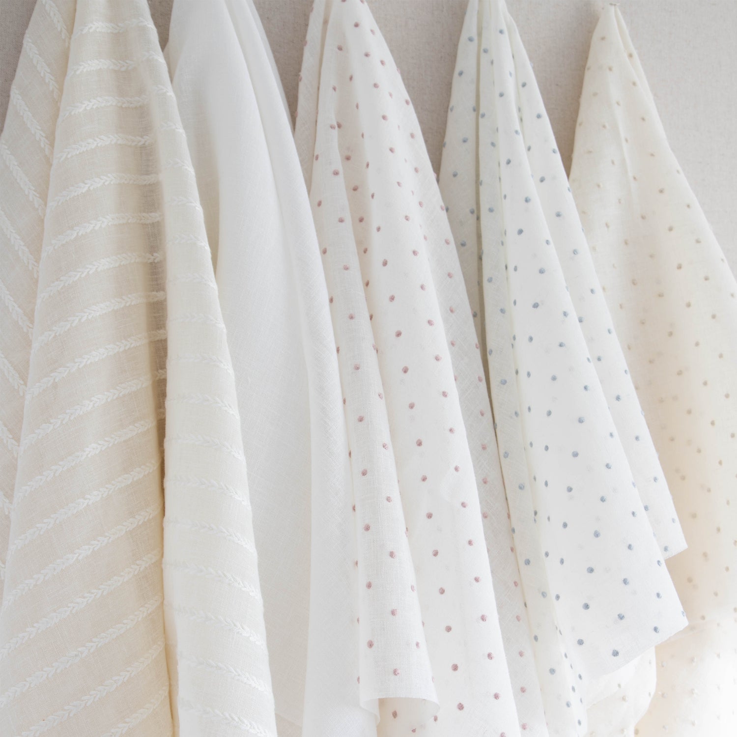 interior design mood board with sheer white fabric, sheer natural fabric with white embroidered stripes, sheer white fabric with cream embroidered polka dots, sheer white fabric with blue embroidered polka dots and sheer white fabric with embroidered pink polka dots  