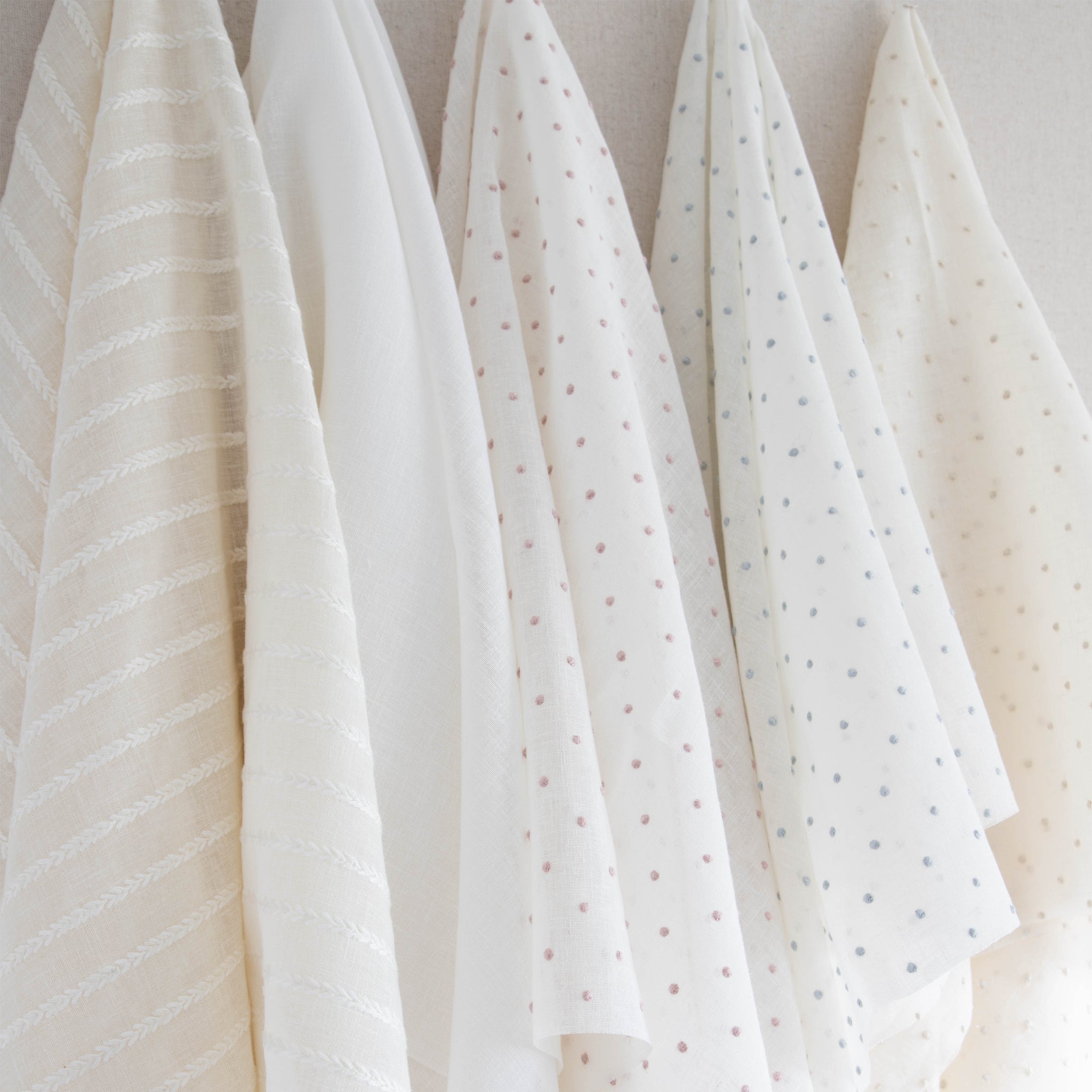 interior design mood board with sheer white fabric, sheer natural fabric with white embroidered stripes, sheer white fabric with cream embroidered polka dots, sheer white fabric with blue embroidered polka dots and sheer white fabric with embroidered pink polka dots  