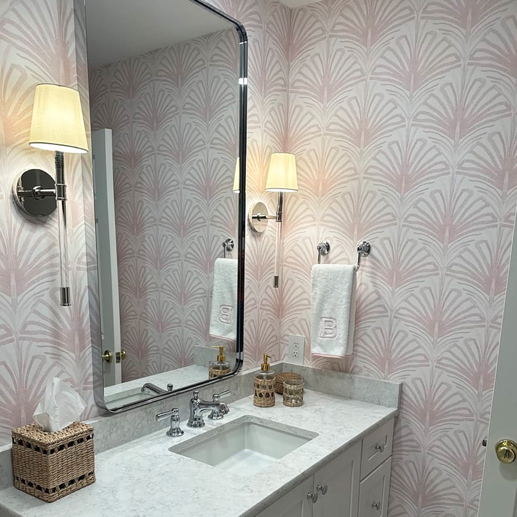 white granite Bathroom sink close-up styled with rose pink palm printed wallpaper