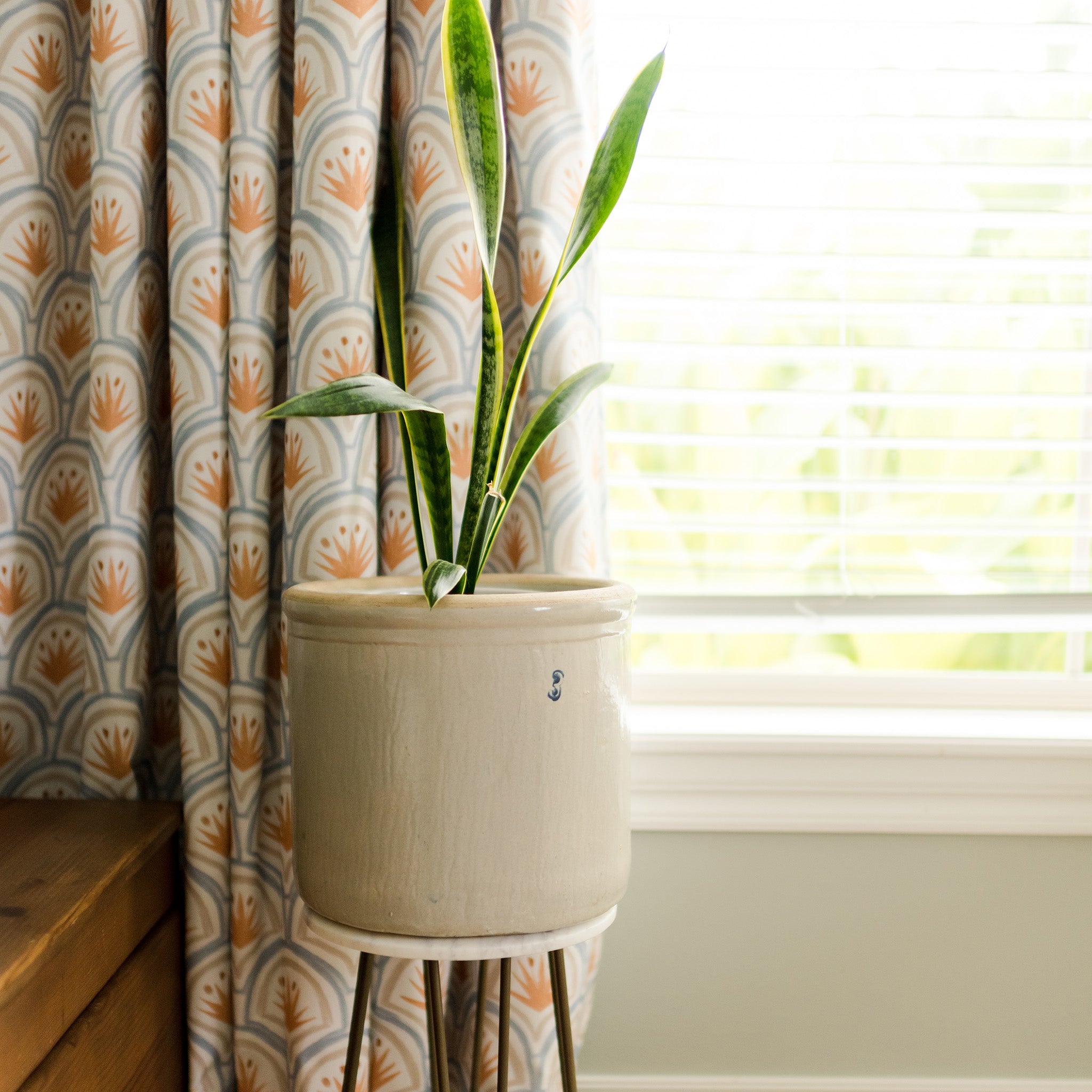 Window close-up styled with Art Deco Palm Pattern Printed Curtains and white Plant-pot in front