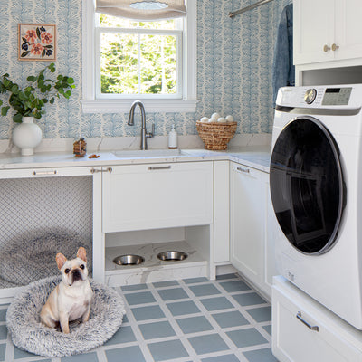 Emma Sky wallpaper with soft blue botanical print in a bright laundry room, made-to-order, short lead times, manufactured in the USA