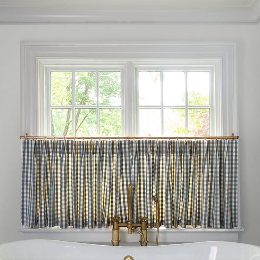 Millie Harbor Tailored Pleat custom cafe curtains in a blue and white gingham pattern brightening a cozy kitchen window.