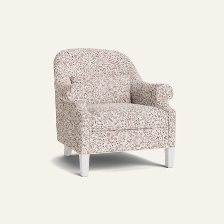 A floral armchair with a white background and pink, green, and blue accents.