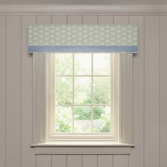 Serena Sea Salt custom cornice in soft seafoam green print with light blue trim, offering made-to-order window elegance